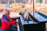 A resident plays the piano at Orchard Cove in Canton, MA