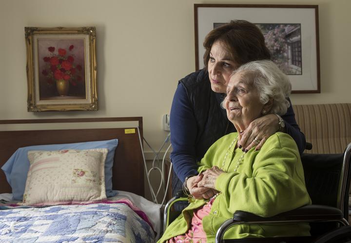 A long-term chronic care patient of Hebrew Rehabilitation Center at NewBridge on the Charles shares a hug with her adult daughter.