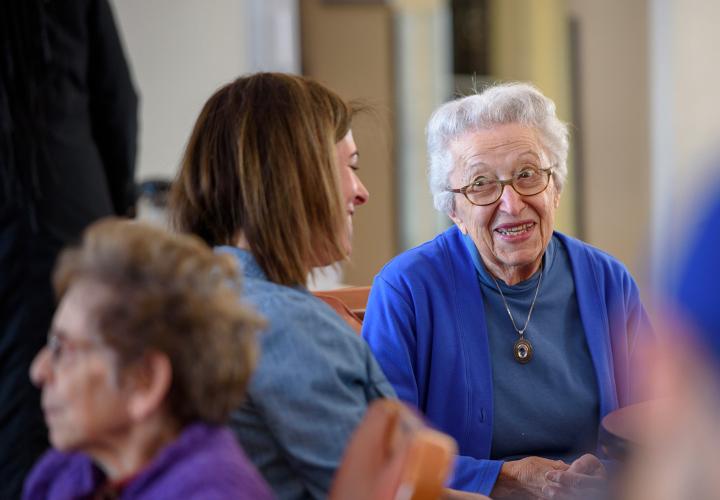 A staff member and resident talk at Center Communities of Brookline in Brookline, MA