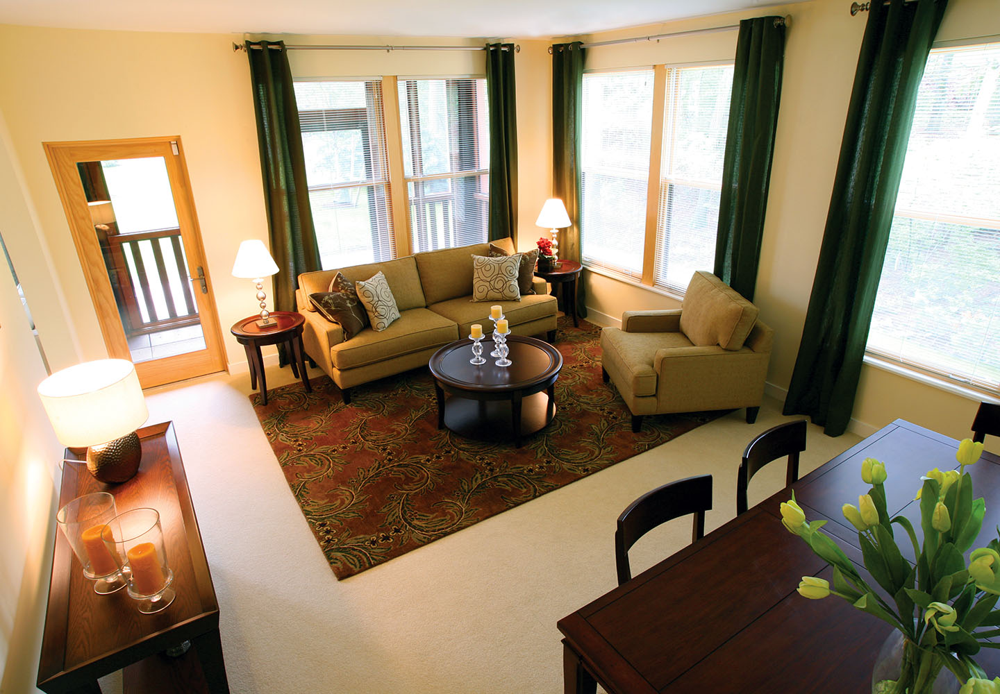 A NewBridge on the Charles apartment interior, showing a corner living room that leads to an enclosed porch.