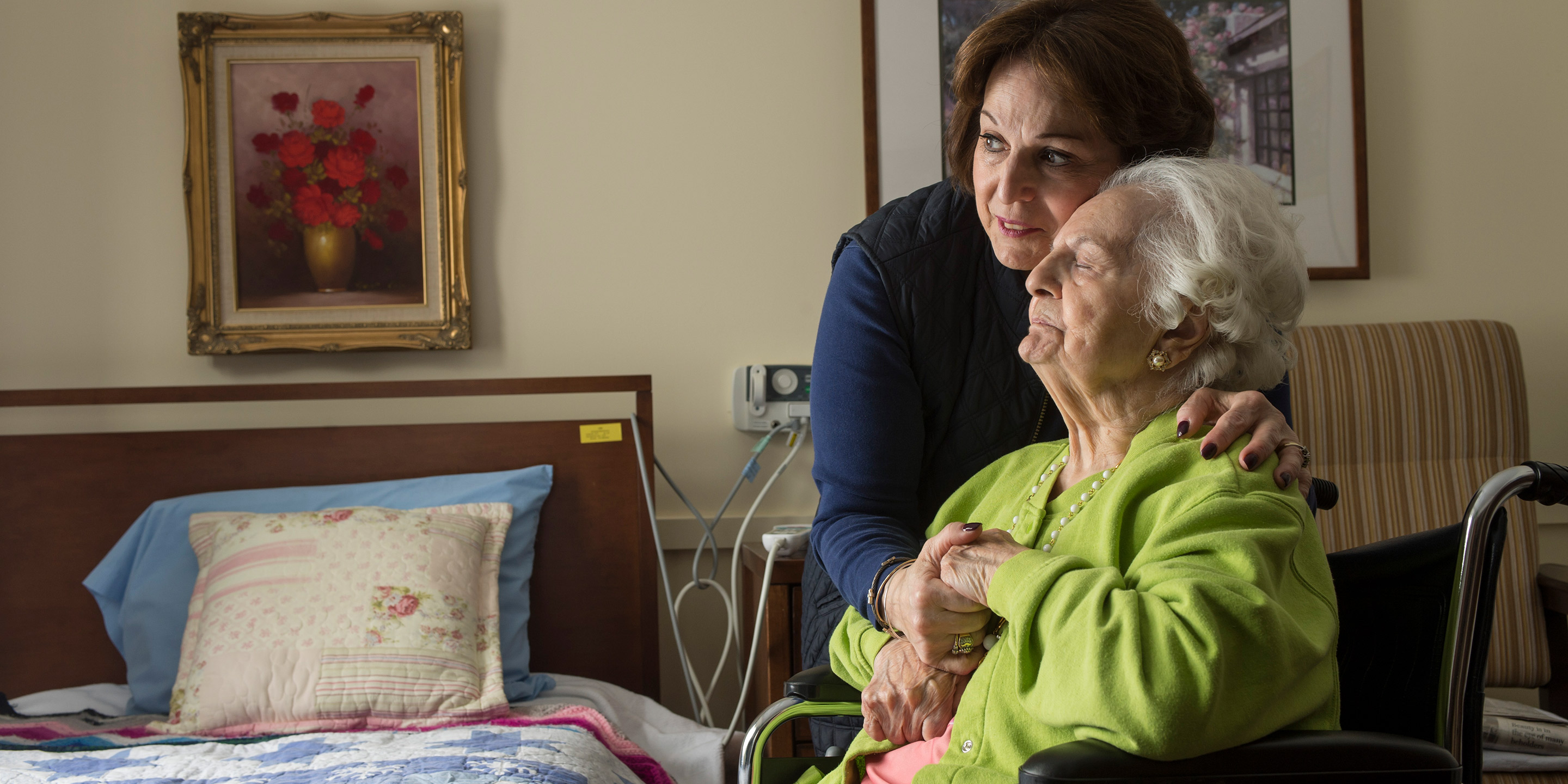 A long-term chronic care patient of Hebrew Rehabilitation Center at NewBridge on the Charles shares a hug with her adult daughter.