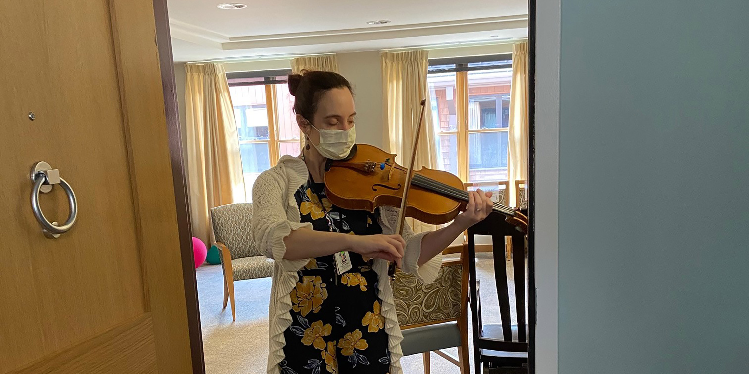 NewBridge on the Charles employee, Leticia Alvaraz, plays a violin while wearing a face mask during the COVID-19 coronavirus pandemic 