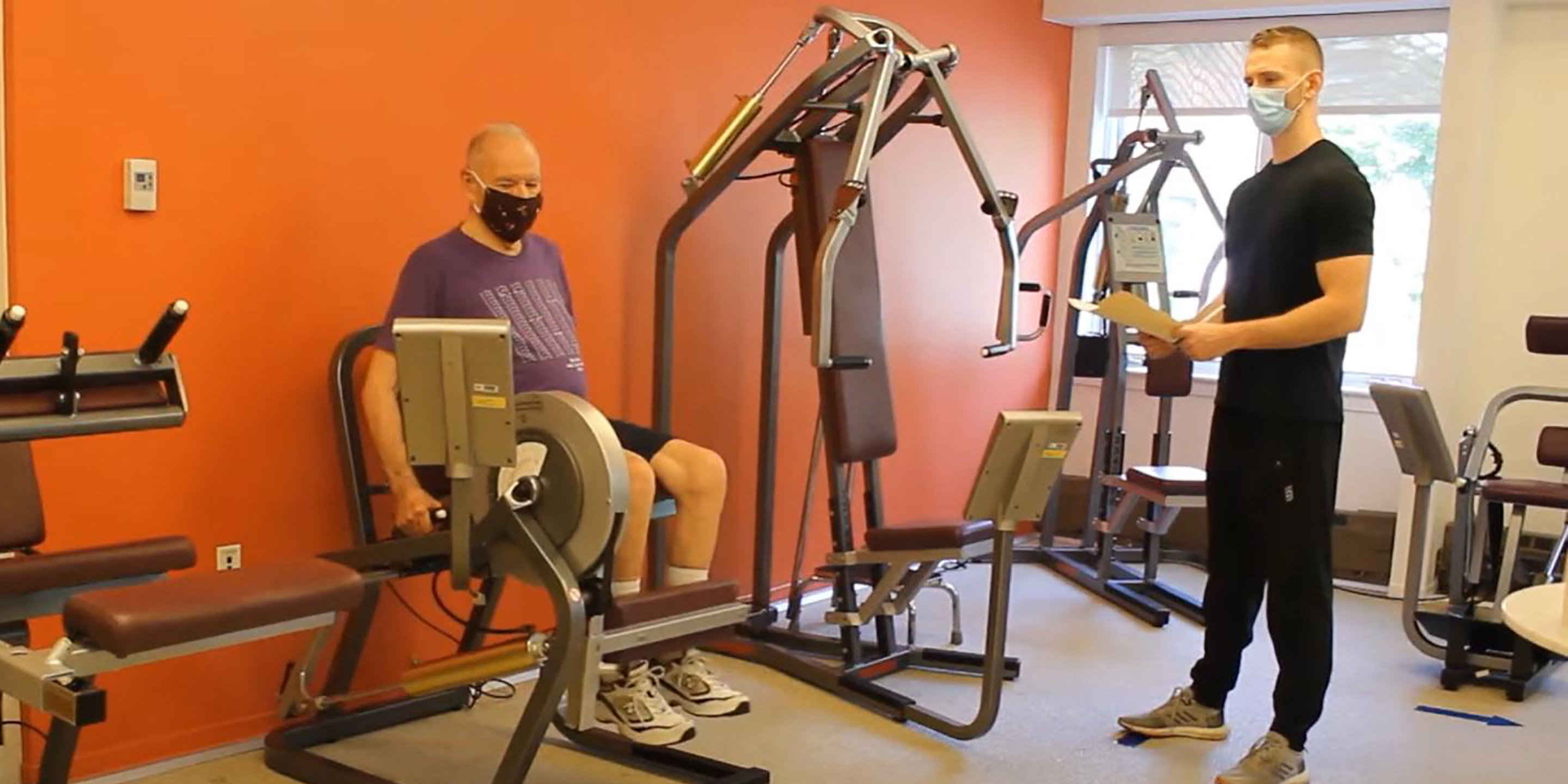 Masked resident works out with an HSL trainer. 