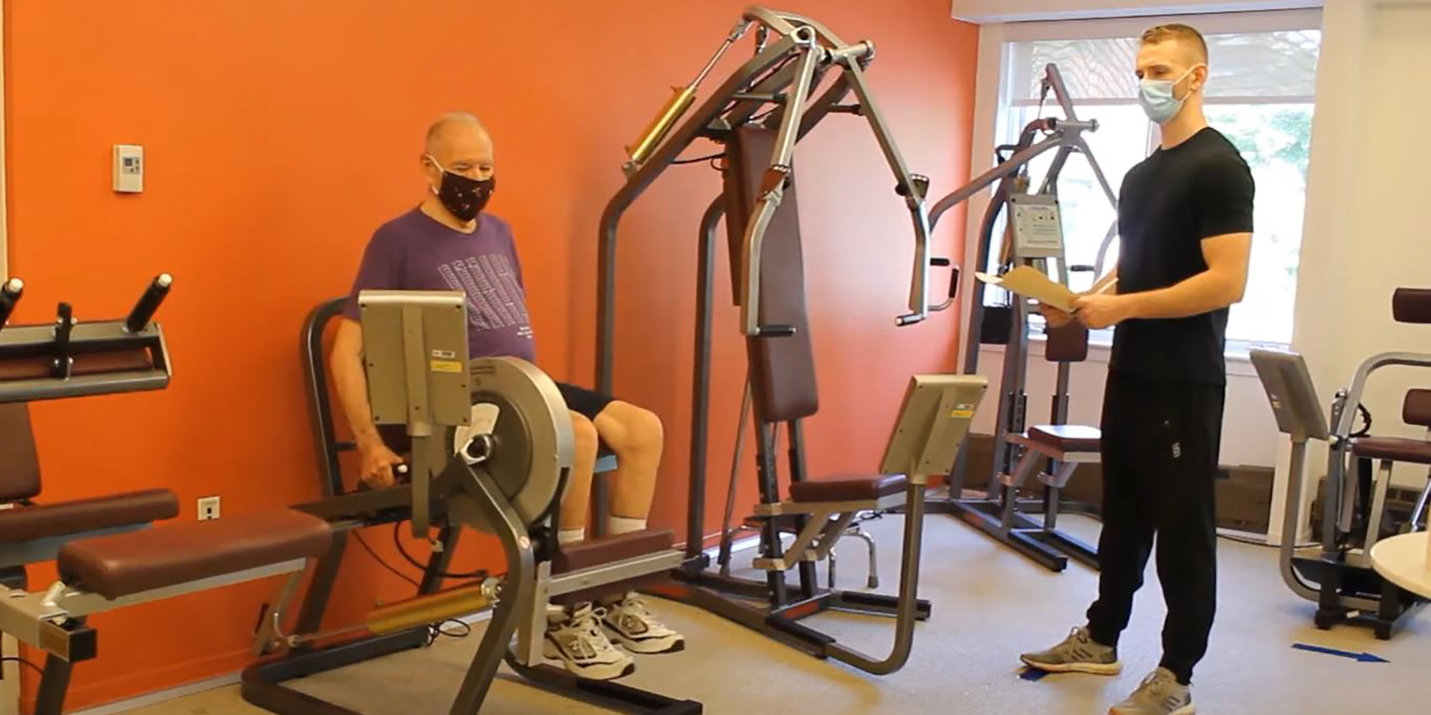 Masked resident works out with an HSL trainer.