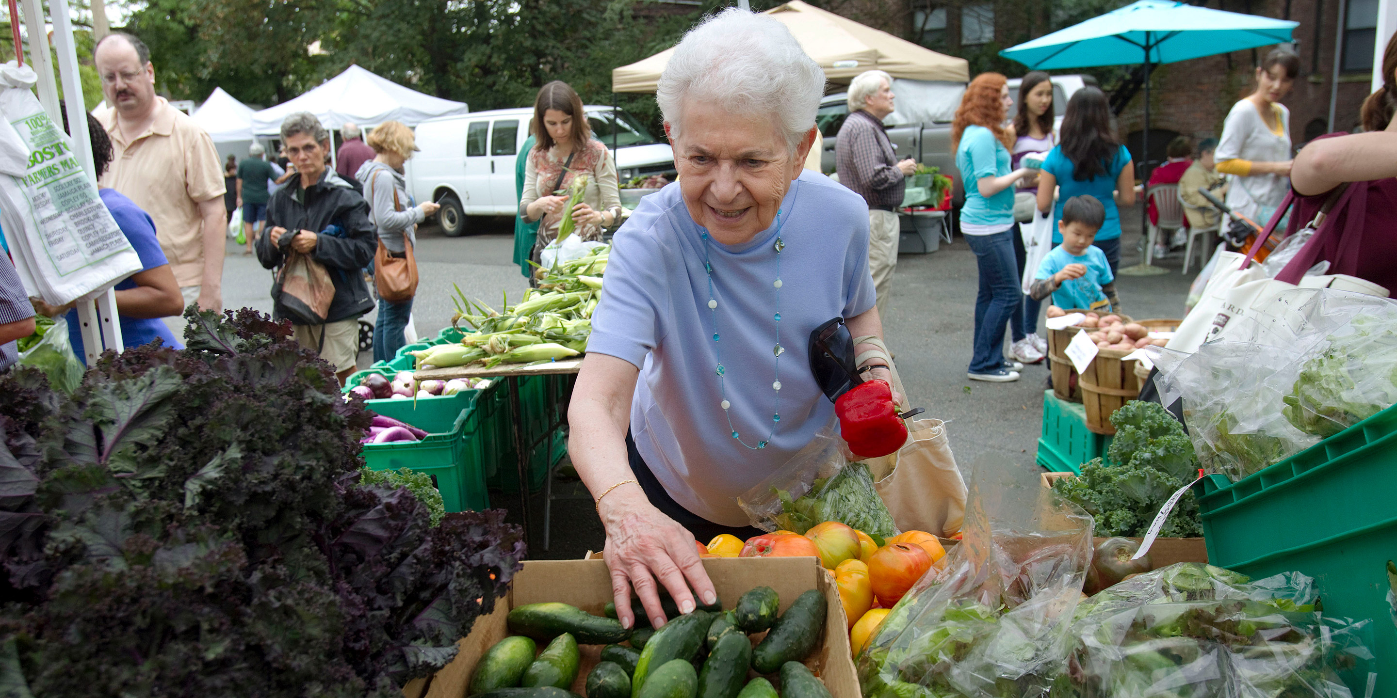 A female resident looks through fresh fruits and vegetables