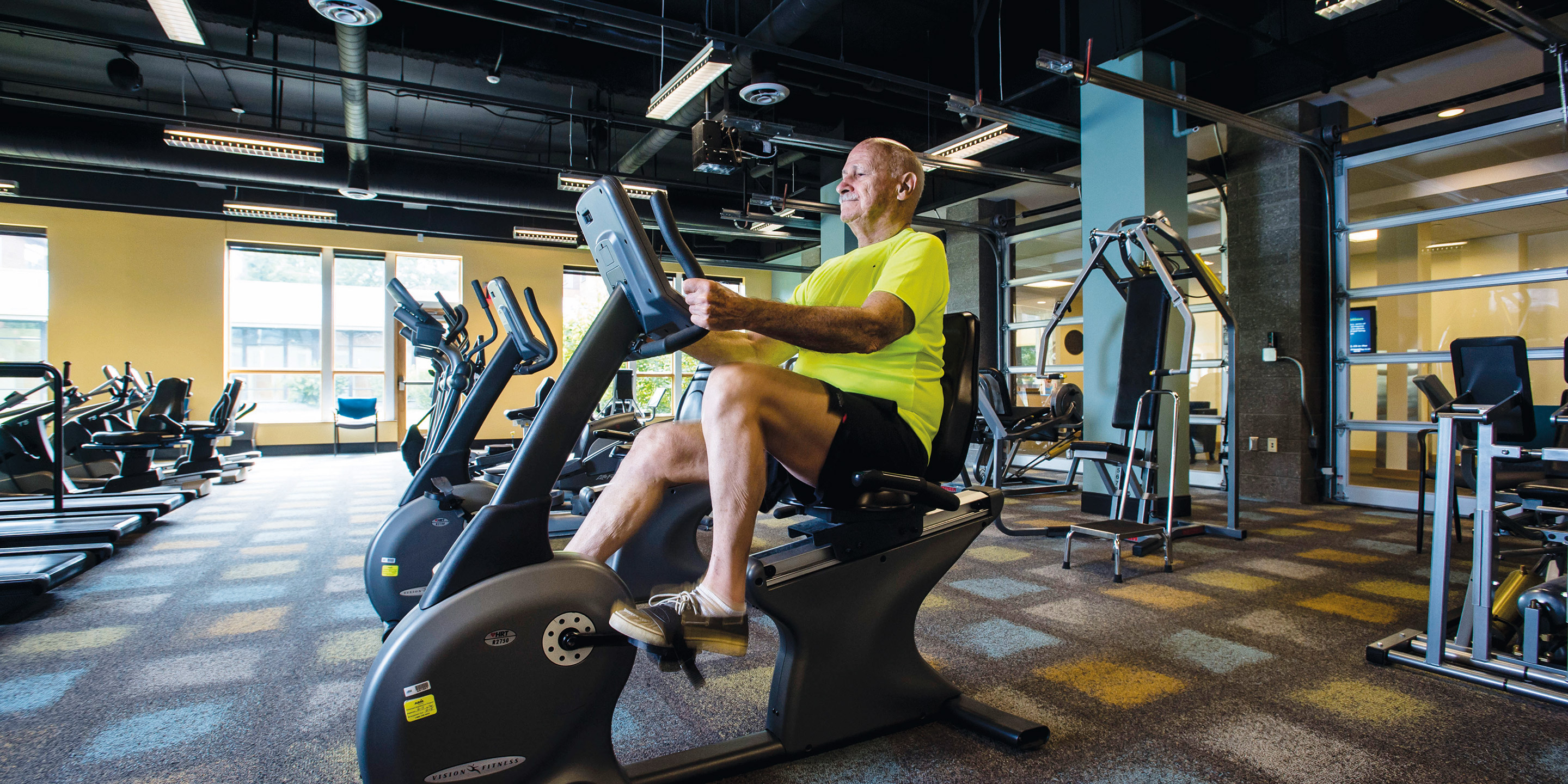 A male resident works out on a stationary exercise bicycle.