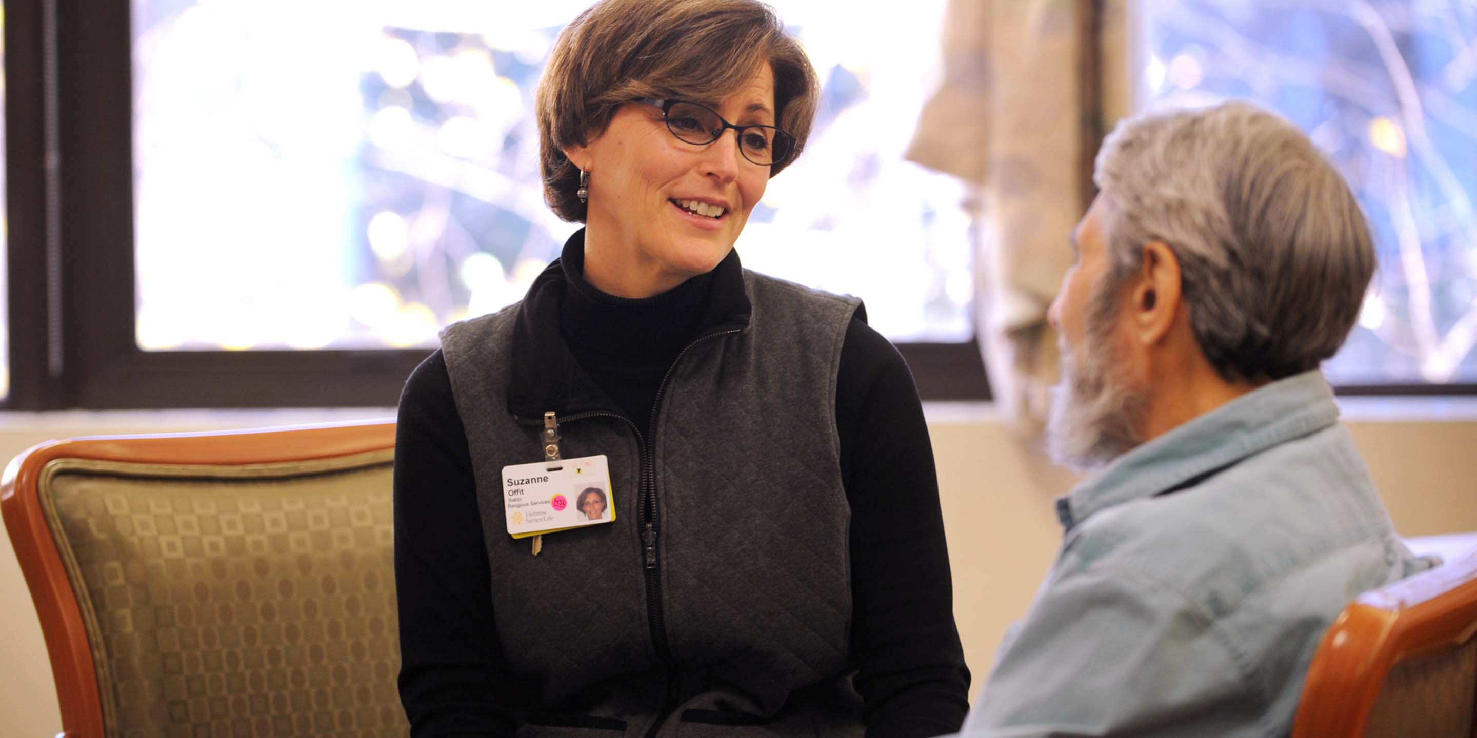 Woman Caretaker Sitting with Male Patient