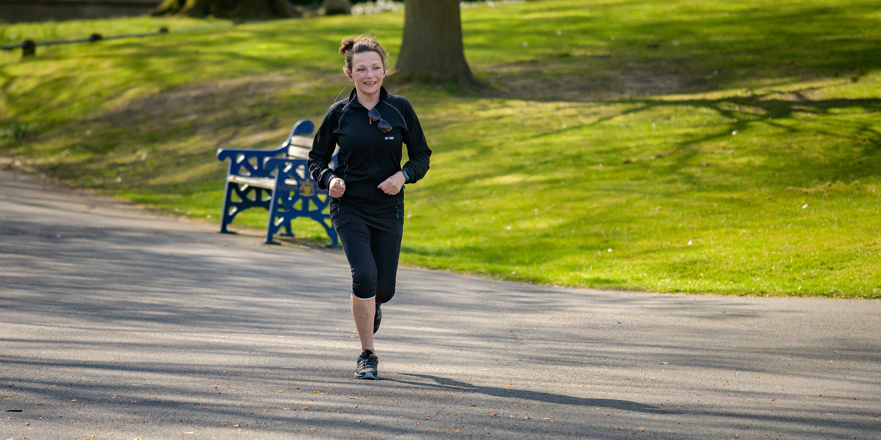Woman in black jacket jogging