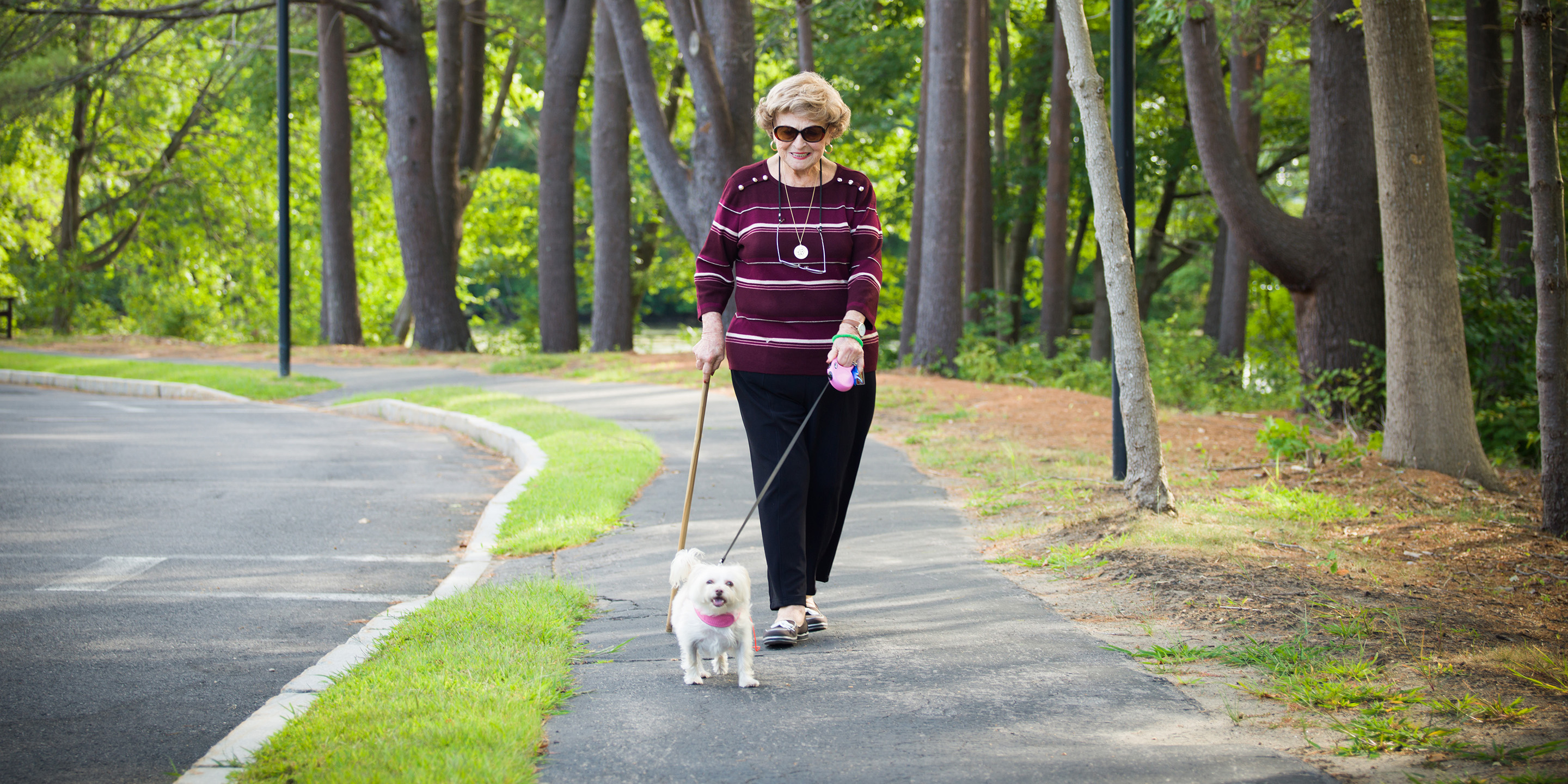 Woman walking outside with her dog.