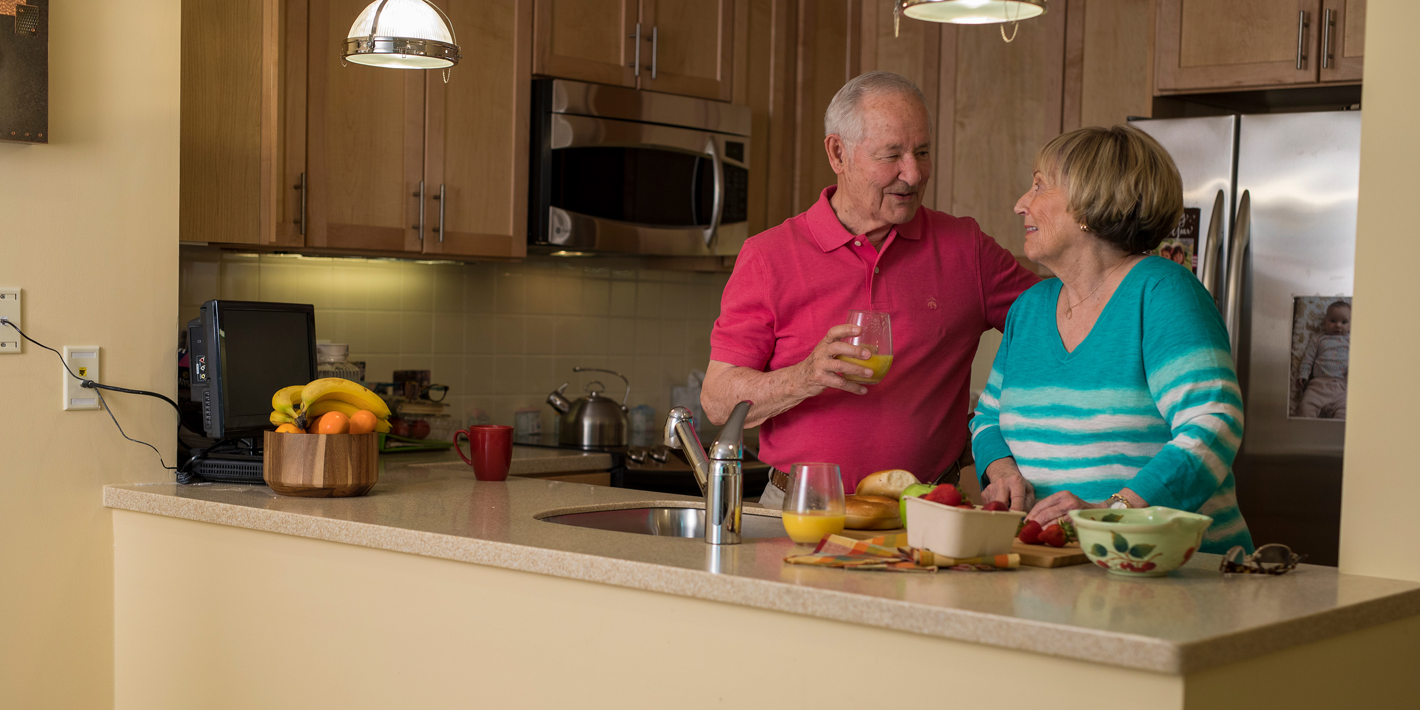 Older couple standing in kitchen