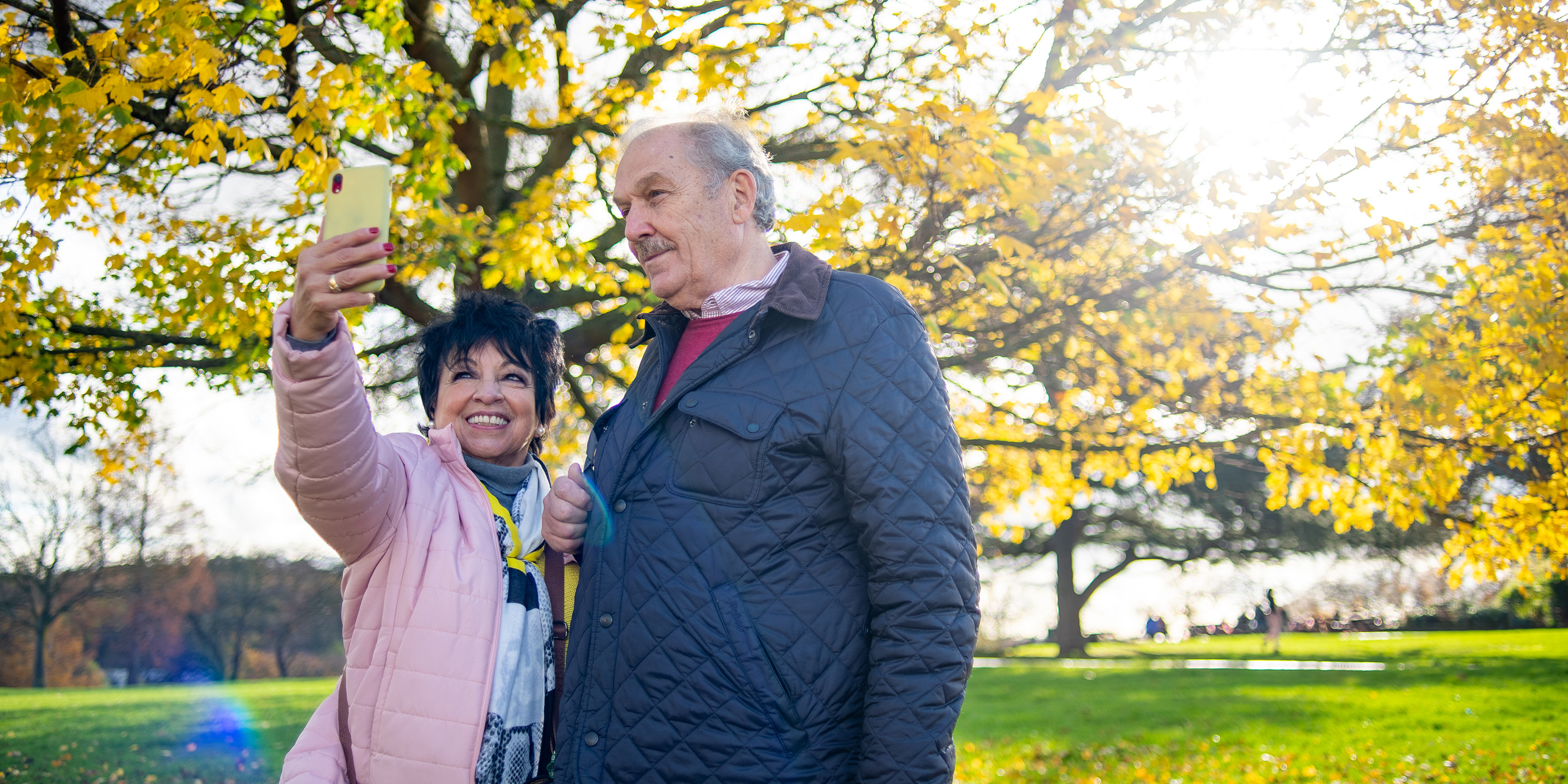 senior couple outside taking a photo