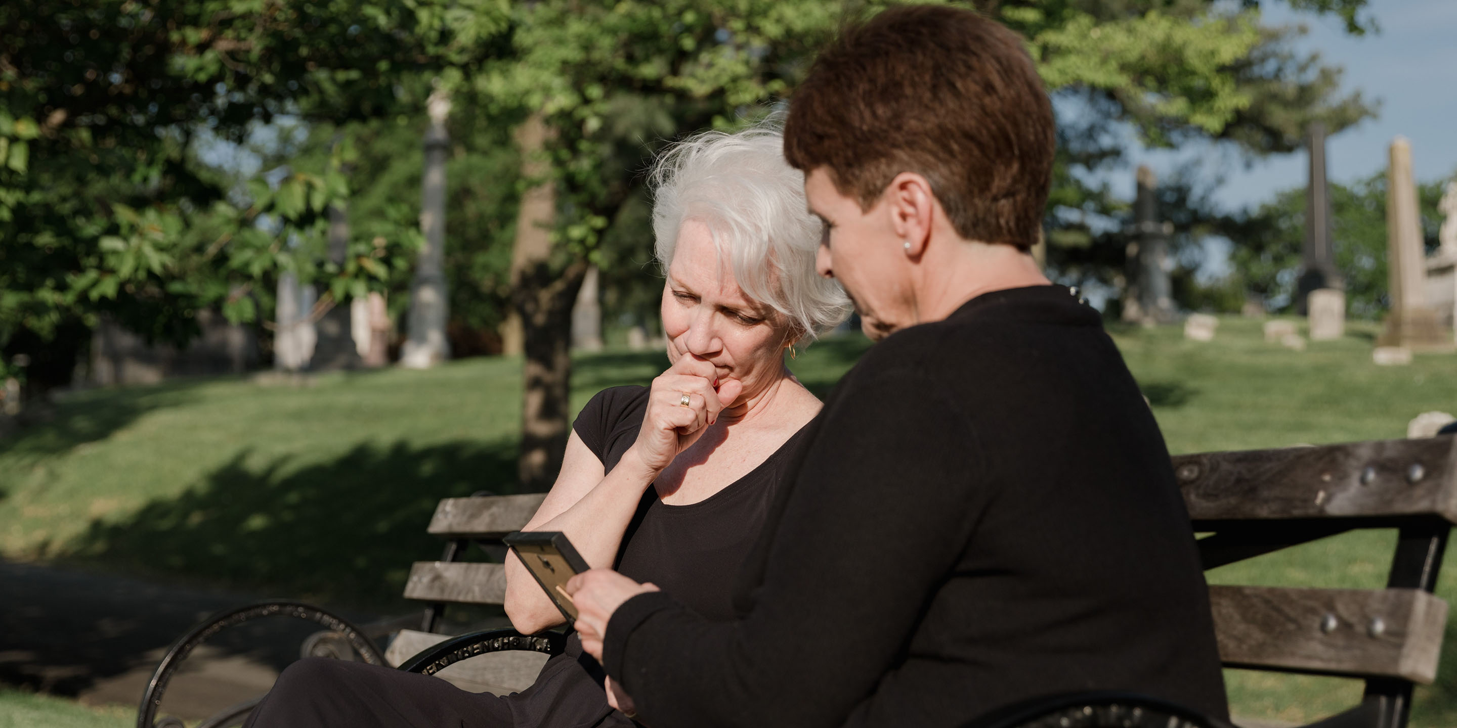 woman sitting with grieving friend