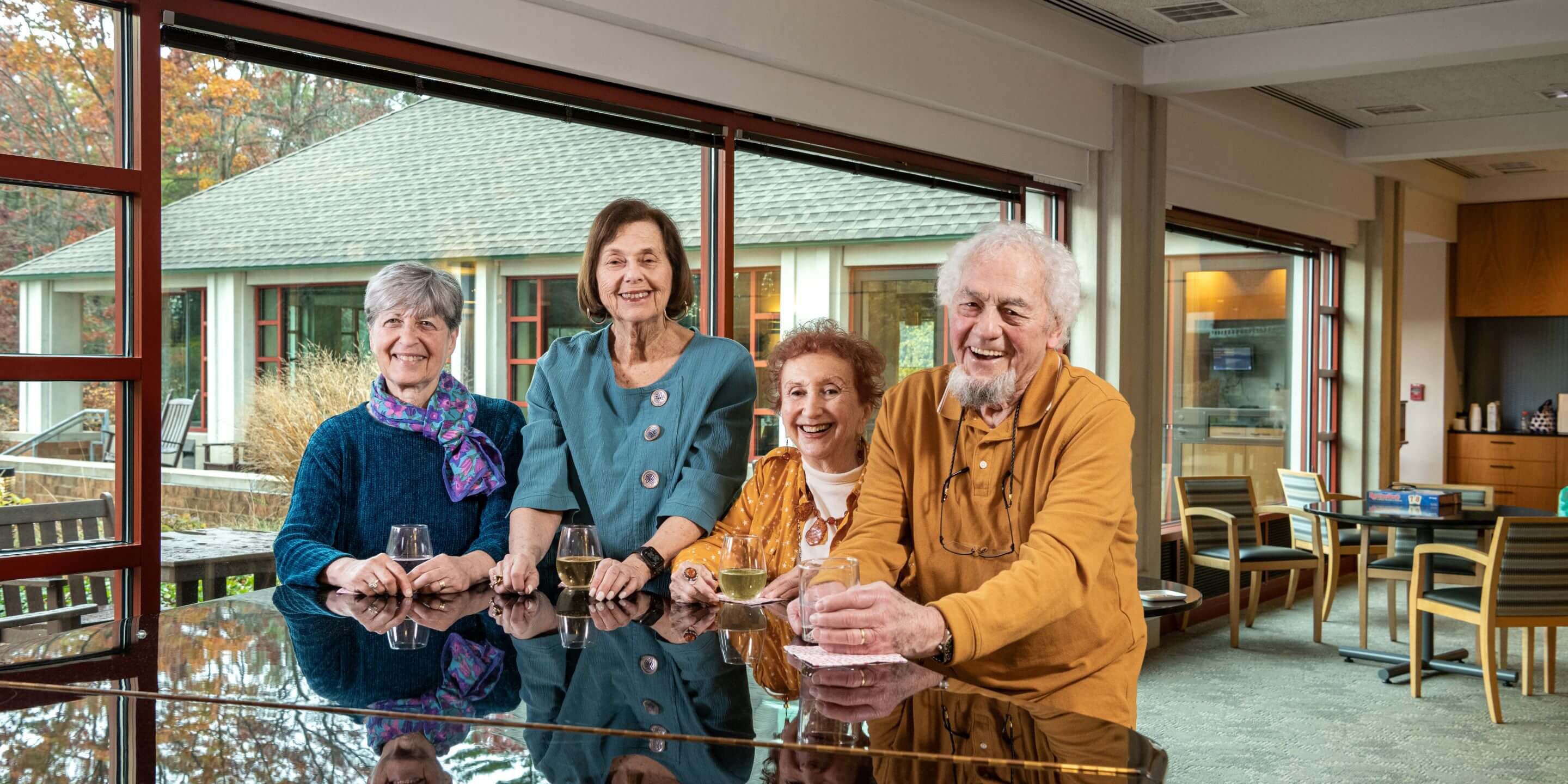 Orchard Cove residents standing by a piano