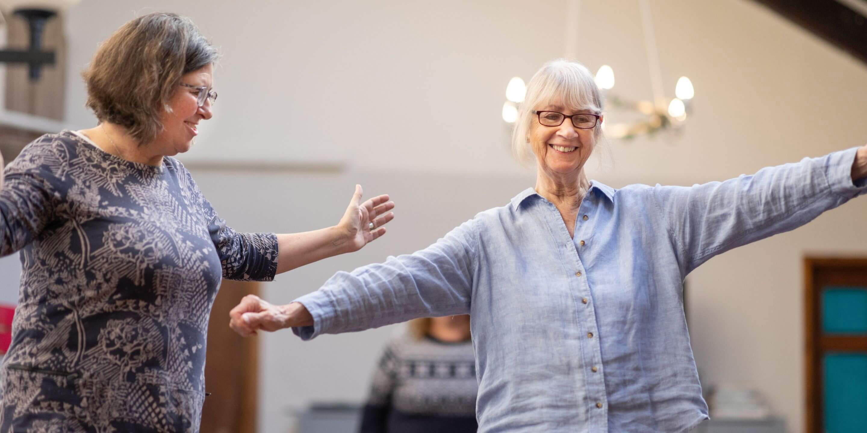 Older woman standing doing an exercise