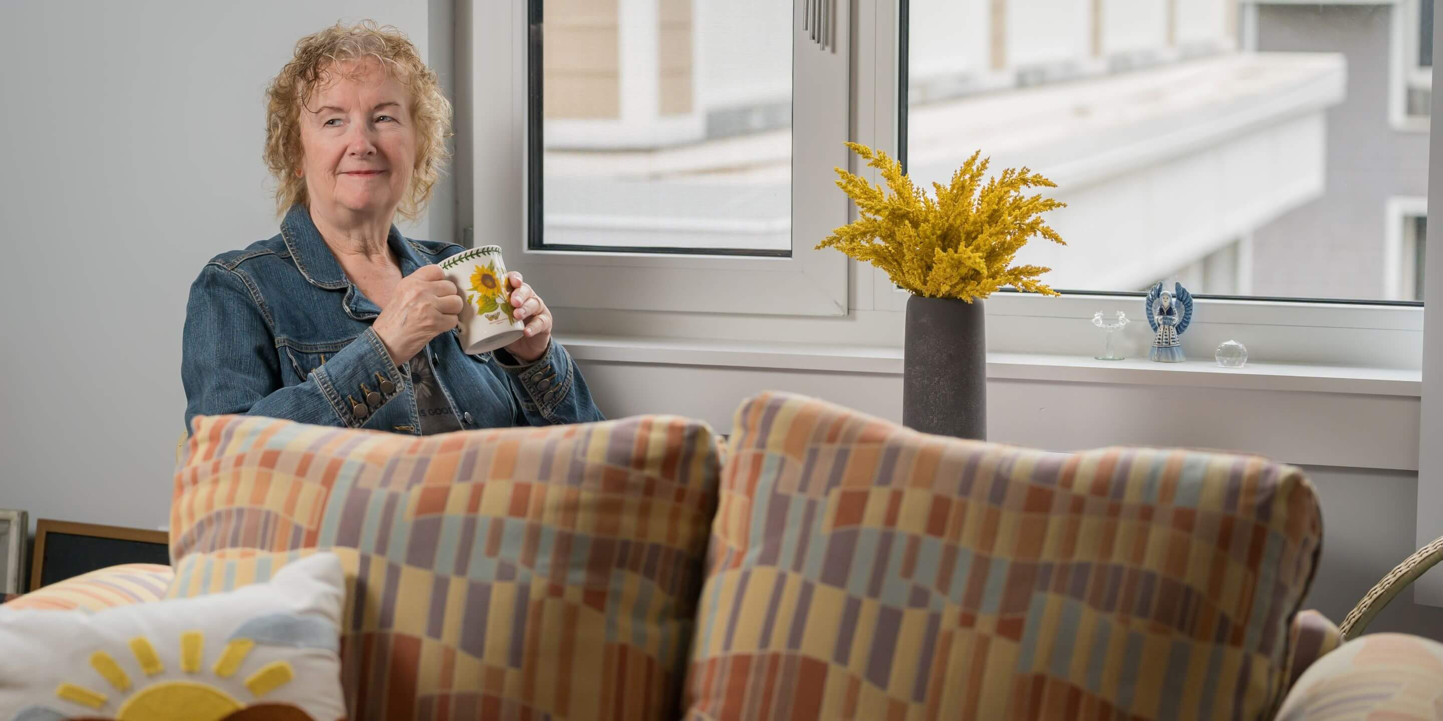 Older woman sitting by a window 