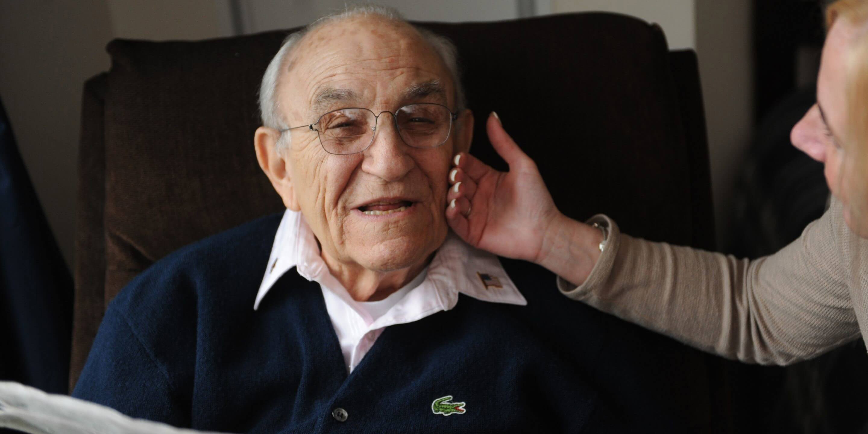 Volunteer showing older man care