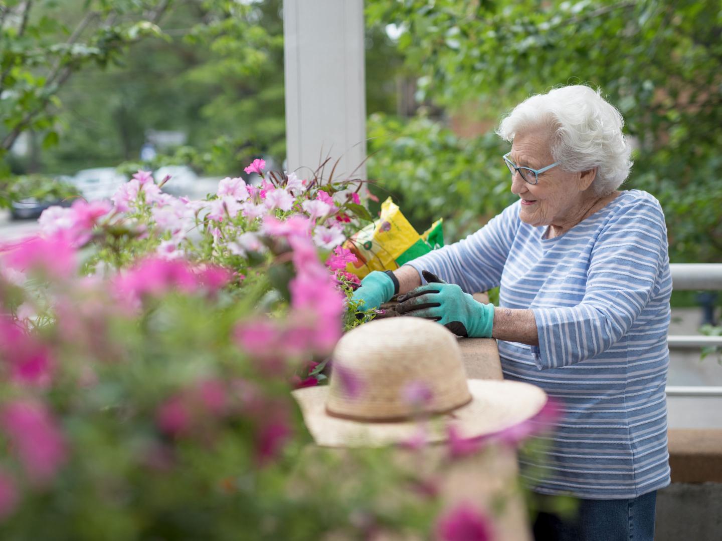 Woman standing in front of her flower garden.