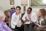 Dr. Jennifer Rhodes-Kropf and students from Harvard Medical School visit with a Center Communities of Brookline resident in their apartment.