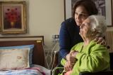 A long-term chronic care patient of Hebrew Rehabilitation Center at NewBridge on the Charles shares a hug with her adult daughter.