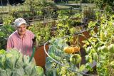 A NewBridge resident waters his vegetables in our raised garden beds