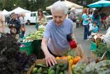 A female resident looks through fresh fruits and vegetables