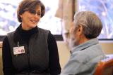 Woman Caretaker Sitting with Male Patient