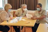 Three women nurses reviewing paperwork