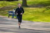 Woman in black jacket jogging