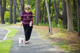 Woman walking outside with her dog.