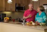 Older couple standing in kitchen