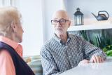 Man sitting with senior woman