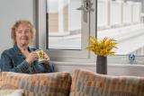 Woman sitting by a window with a mug
