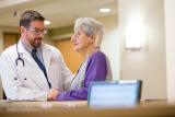 Doctor sitting with woman