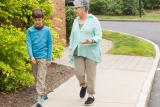 Older woman walking with young boy