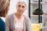 Older woman sitting with another woman