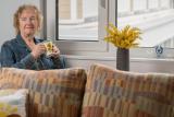 Older woman sitting by a window 