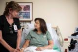 Woman nurse sitting with a woman patient 
