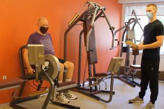 Masked resident works out with an HSL trainer. 