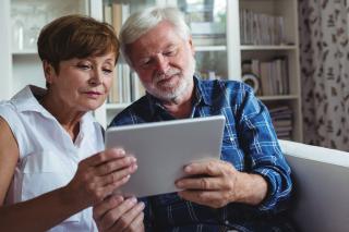 Woman sitting with senior man