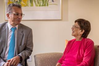 Doctor sitting with woman