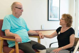 Staff member sitting with patient 