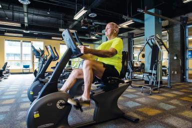 A male resident works out on a stationary exercise bicycle.