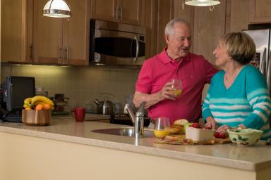 Older couple standing in kitchen