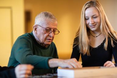 Young girl sitting with older male