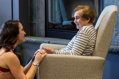woman sitting with senior woman