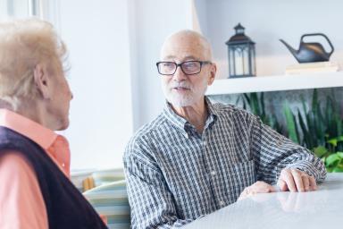 Man sitting with senior woman