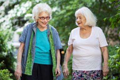 Two older women walking together