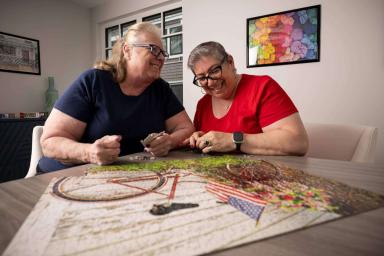 Two older women working on a puzzle
