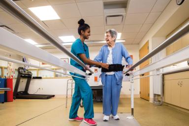 Nurse standing with patient