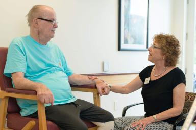 Staff member sitting with patient